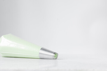 Green buttercream in a piping bag, American buttercream in a piping bag for icing cake, frosting for decorating cake