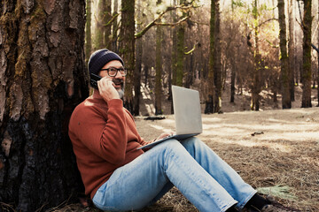 One man using technology connection in nature park forest woods. Remote worker small travel business lifestyle people. Working in the nature alternative office. Small business. Travelers job life