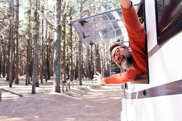 One man enjoying the view outside the window of a motorhome camper van enjoying vanlife and alternative travel vehicle vacation holiday. Freedom. Nomadic lifestyle people fulltimers. Free parking van