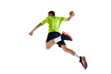 Fototapeta na wymiar Competitive and concentrated young guy, handball player in motion during game, training against white studio background. Concept of professional sport, tournament, competition