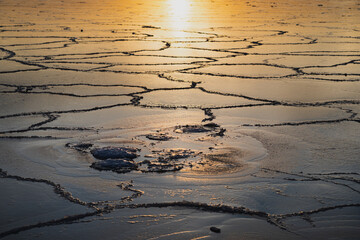 Frozen Baltic Sea in winter at sunrise.