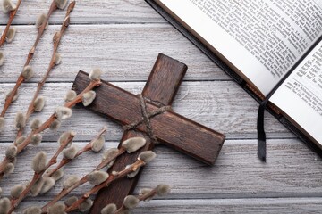 Christian wooden cross with willow and bible