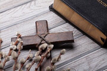 Christian wooden cross with willow and bible