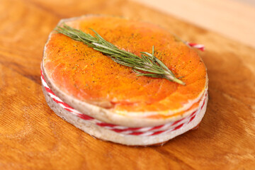 To bake a piece of salmon, add oil and a sprig of rosemary