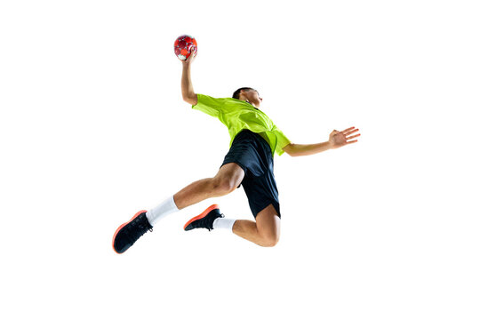 Bottom view image of young guy, handball athlete in motion during game, playing, practicing against white studio background. Concept of professional sport, tournament, competition