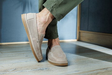Male legs in beige leather shoes. Men's classic shoes.