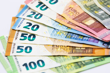 Pile of euro banknotes of 100, 50, 20, 10 and 5 euros. White background