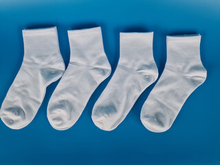 Row of white socks on a blue background