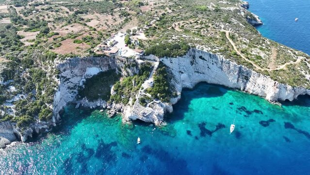 Blue Caves located between Aghios Nikolas and Cape Skinnari. Blue caves in zakynthos, Greece. Potamitis Dive Spot, Zakynthos, greece. Skinari View Point. Aerial drone view Turquoise ionian sea.