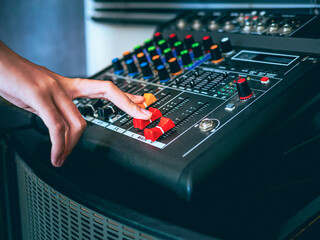 Sound engineer hands adjusting control sound mixer in recording, broadcasting studio,Sound mixer....