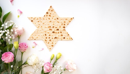 Passover. banner of Traditional Matzo shape of star Magen David  decorate by pink flowers on white background. top view. Holiday of Jewish people, Spring Holiday. Fasting time