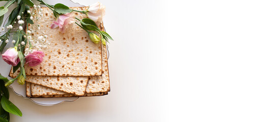 Passover. Holiday of Jewish people. banner of Traditional Matzo prepared for Passover decorate by flowers on white background. top view. Spring Holiday. Fasting time