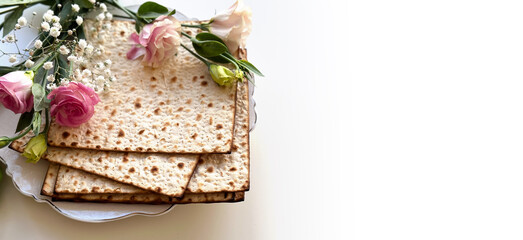 Passover. Holiday of Jewish people. Traditional Matzo prepared for Passover decorate by flowers on white background. top view. Spring Holiday. Fasting time