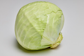 a whole green cabbage on a table.