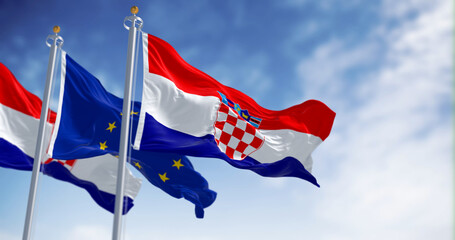 Flags of Croatia and the European Union fluttering together on a clear day