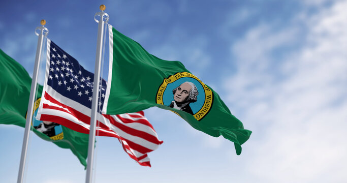 Washington state flags waving with the american flag