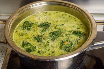 spinach soup in a pot on the stove.