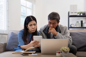 Serious stressed asian senior old couple worried about bill discuss unpaid bank debt paper payment...