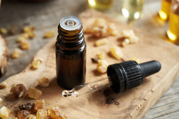 A dark bottle of frankincense essential oil with boswellia resin