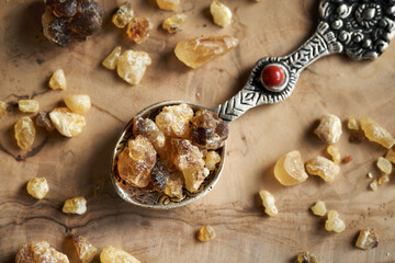 Frankincense resin on a metal spoon on a table