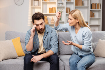 Emotional aid for struggling families depicted as man and woman arguing intensely on a couch