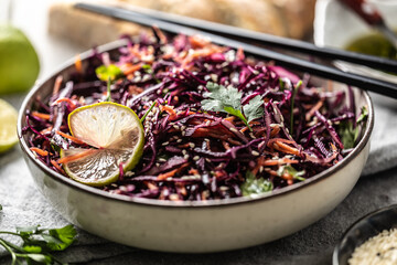Asian red cabbage and carrot salad seasoned with coriander and sesame