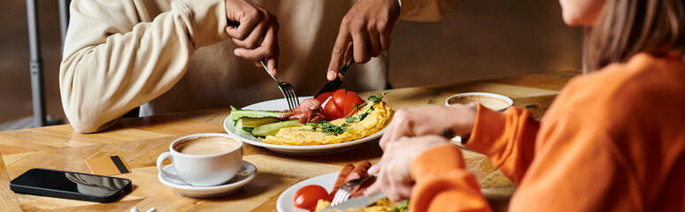 diverse couple enjoying breakfast with delicious omelette,  and sausages near cups of coffee, banner
