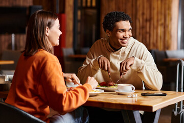 happy diverse couple enjoying coffee and meal at a rustic wooden table in charming restaurant