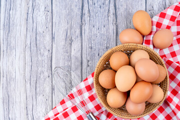 Chicken eggs on red classic tablecloth.