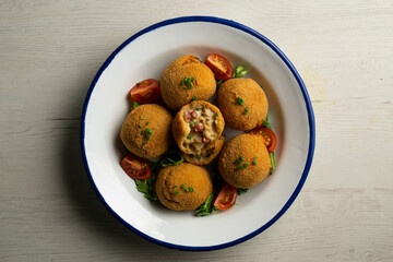 Spanish croquettes made with bechamel sauce and stuffed with octopus. Traditional tapa from northern Spain.