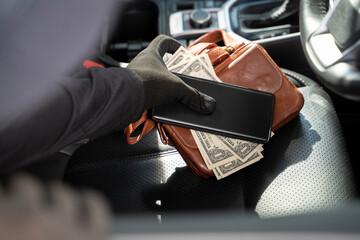 Thieves steal wallet and phone from car seat.