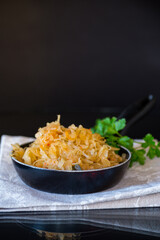 cabbage stewed with spices and carrots in a frying pan ,