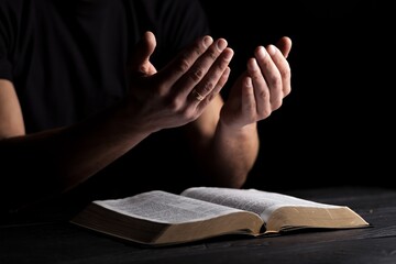 Man with bible praying. Concept religion and faith.