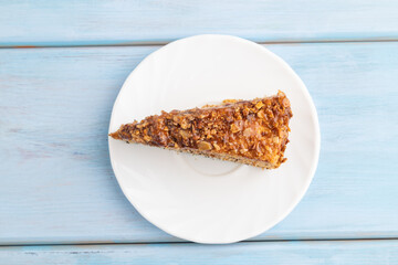 Walnut and hazelnut cake with caramel on blue wooden. top view, flat lay, copy space.