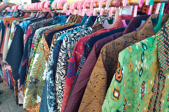 batik clothes hanging on hangers neatly arranged