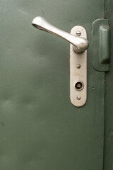 Door handle from a train waggon with green background