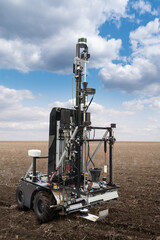 Autonomous robot for measuring soil quality in an agricultural field. Smart farming concept