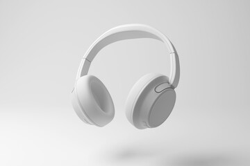 White headphones floating in mid air on white background in monochrome and minimalism. Illustration of the concept of music