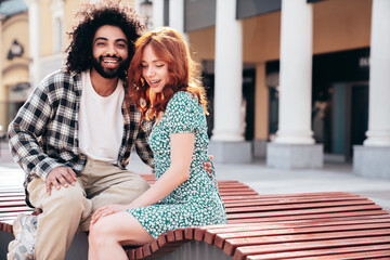 Smiling beautiful redhead  woman and her handsome boyfriend. Model in casual summer clothes. Happy...