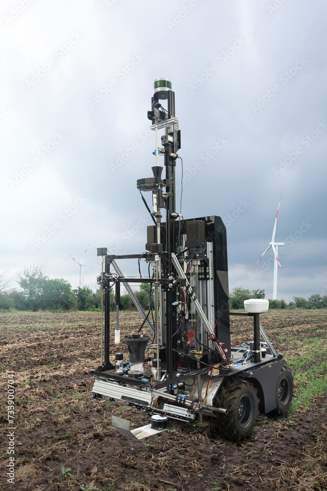 Aufkleber autonomous robot for measuring soil quality in an agricultural field. wind turbine on a horizon. sma