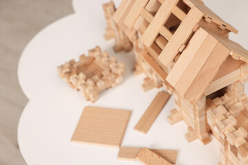 Wooden entry gate and building blocks on white table indoors, space for text. Children's toy