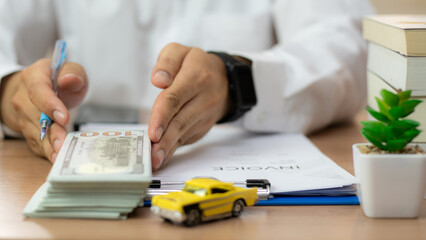 Closeup hand giving a car key and money for loan credit financial and rental. car loan concept,...