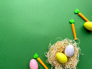 Happy Easter postcard. Colored Easter eggs in nest on green background, image with selective focus,...
