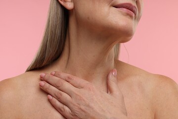 Fototapeta premium Mature woman with healthy skin on pink background, closeup