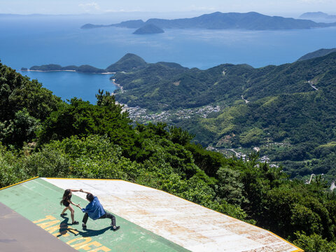 Suo-Oshima, Yamaguchi prefecture, Japan - August 25, 2018: Couple posing for photos at Mt Dake observation point