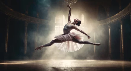 Wall murals Dance School young and graceful ballet dancer in white tutu is performing choreography on theater stage under dramatic lights