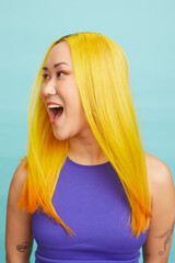 Young woman with long yellow hair and open mouth, looking away