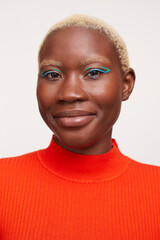 Portrait of woman with short white hair and blue make up