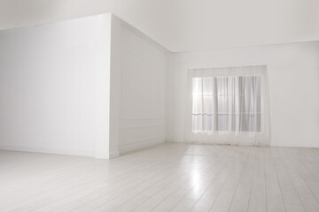Empty room with white walls and large window