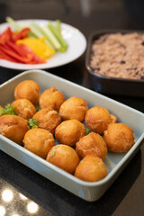 Baked balls of appetizers in baking dish